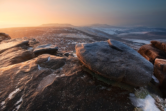 Golden light reflected on ice at Stanage Edge